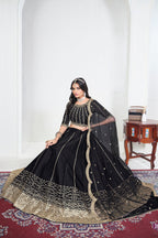 Alternate view of a black embroidered lehenga with mirror work on the lehenga skirt, seated pose, full outfit visible. All-over mirror work.