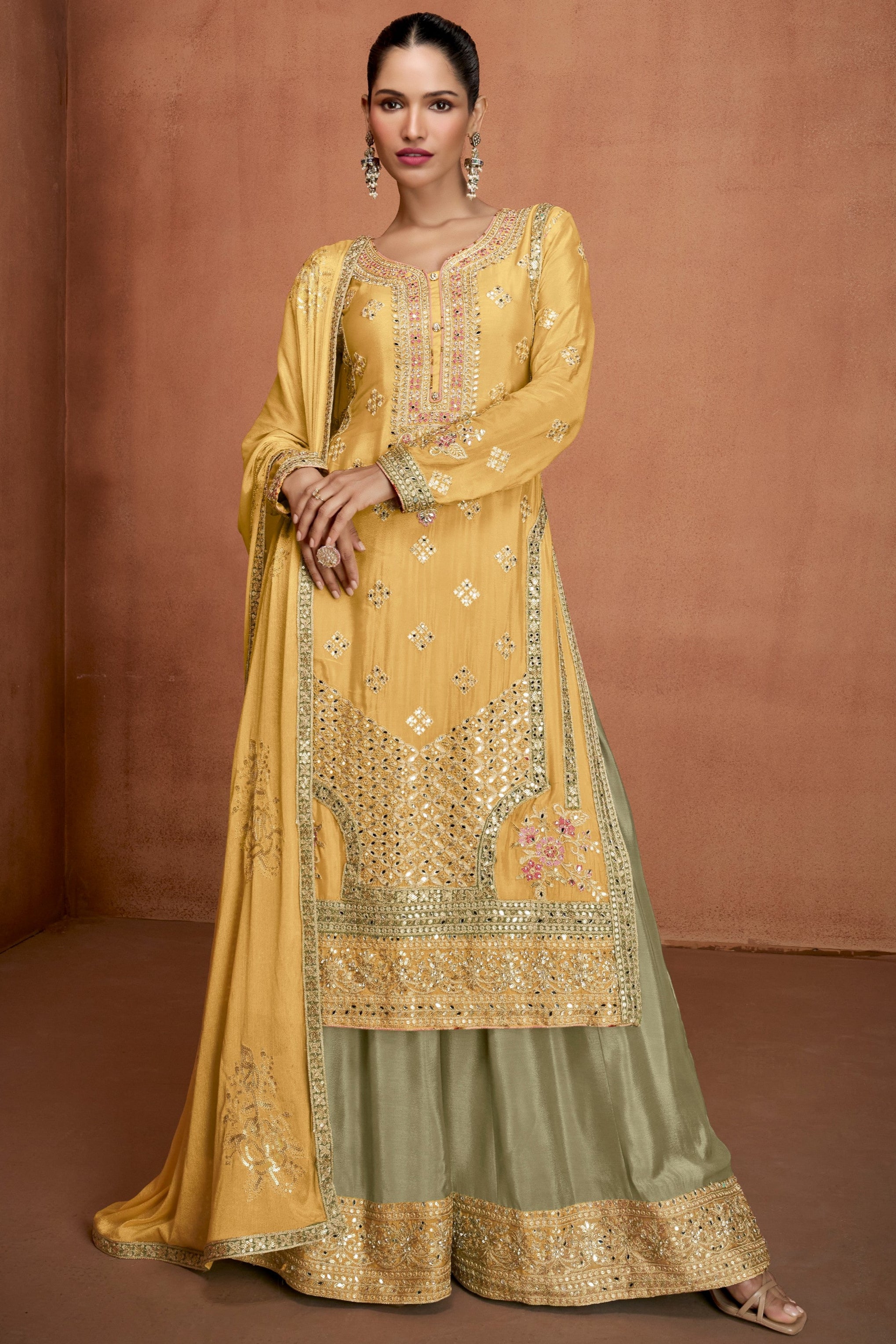 Woman wearing a yellow embroidered traditional outfit with Gulkaray branding.