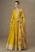 A full front view of a woman wearing a yellow haldi dress for women in chinon silk with thread embroidery.