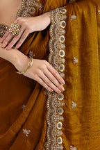 Gold Tissue Saree with Stitched Blouse in Pearl and Zari Work