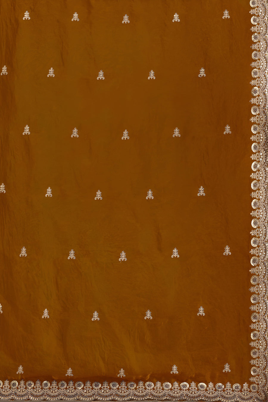 Brown fabric with white embroidered patterns and a decorative border.