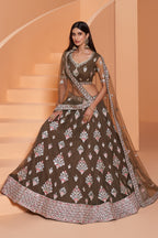 Full front view of the olive green lehenga choli with dupatta draped over the shoulder, mirror work border and floral embroidery — a graceful lehenga for mehndi functions.