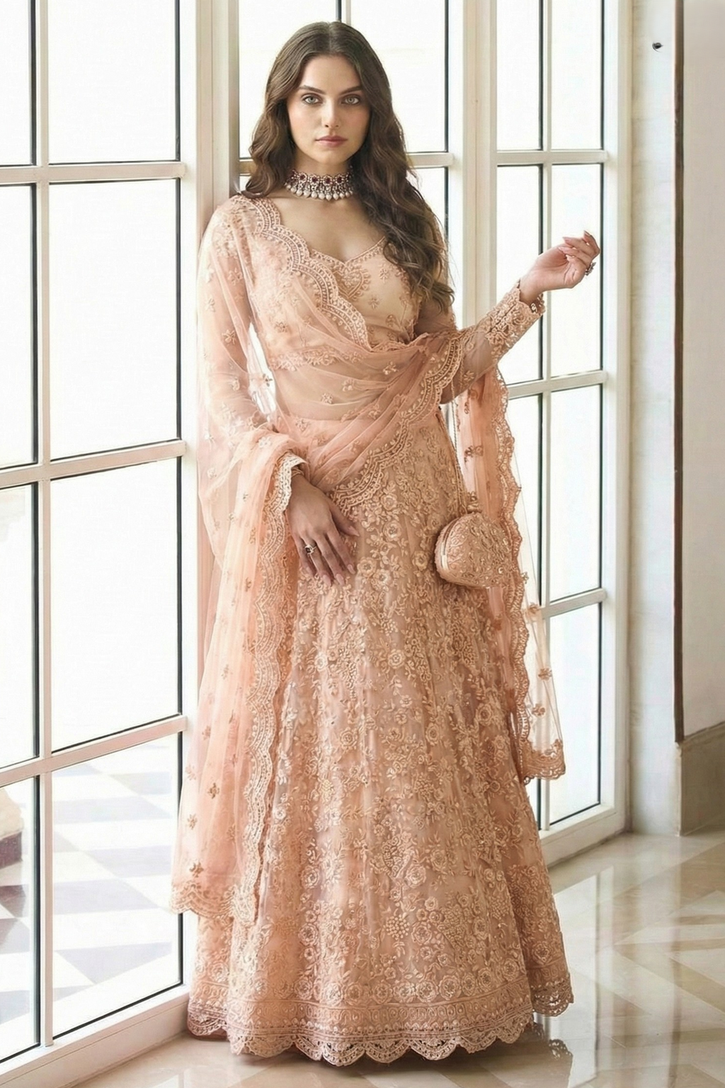 Full front view of the peach lehenga choli with dupatta draped over the shoulder, long sheer sleeves and potli bag — graceful lehengas for wedding guest styling.