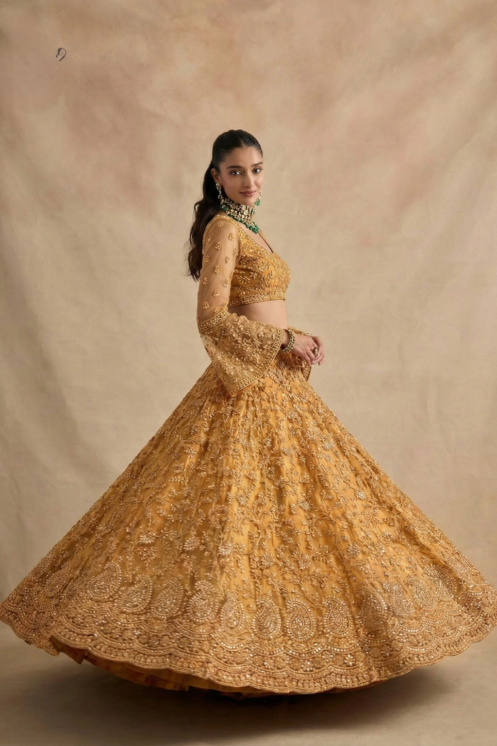Twirl view of the golden lehenga showing the flared embroidered skirt and open back blouse — festive sangeet outfits in shimmering gold net with stone work.
