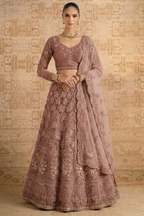 Full front view of the mauve lehenga choli with long embroidered sleeves, V neck blouse and scalloped net dupatta — graceful long sleeve lehengas for wedding guest styling.