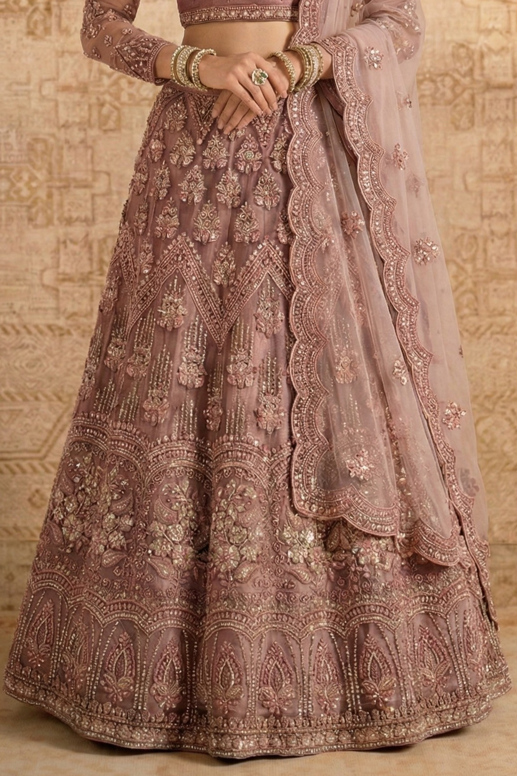 Waist-down view of the mauve net lehenga showing dense floral embroidery and the scalloped dupatta border — a richly worked net lehenga with hand embroidery and sequin detailing.