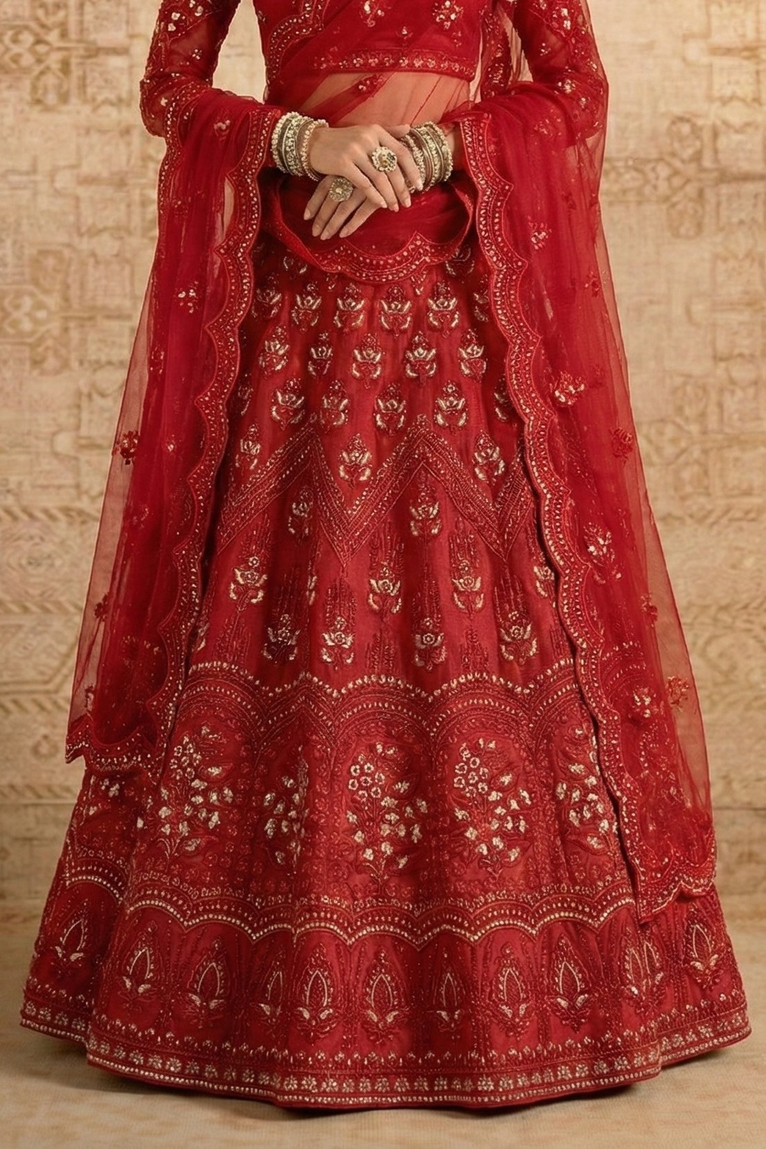 Waist-down view of the red lehenga with all-over gold embroidery and scalloped dupatta edges — a festive lehenga choli for wedding functions in rich red net.
