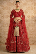 Model wearing a red net lehenga choli with long sheer embroidered sleeves, V neck blouse and potli bag — a striking long sleeve reception lehenga with gold hand embroidery.