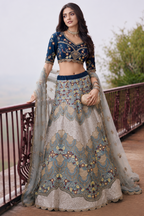 Full view of a navy blue blouse with silver a line lehenga for wedding with detailed embroidery work on the half sleeve silk blouse neckline.