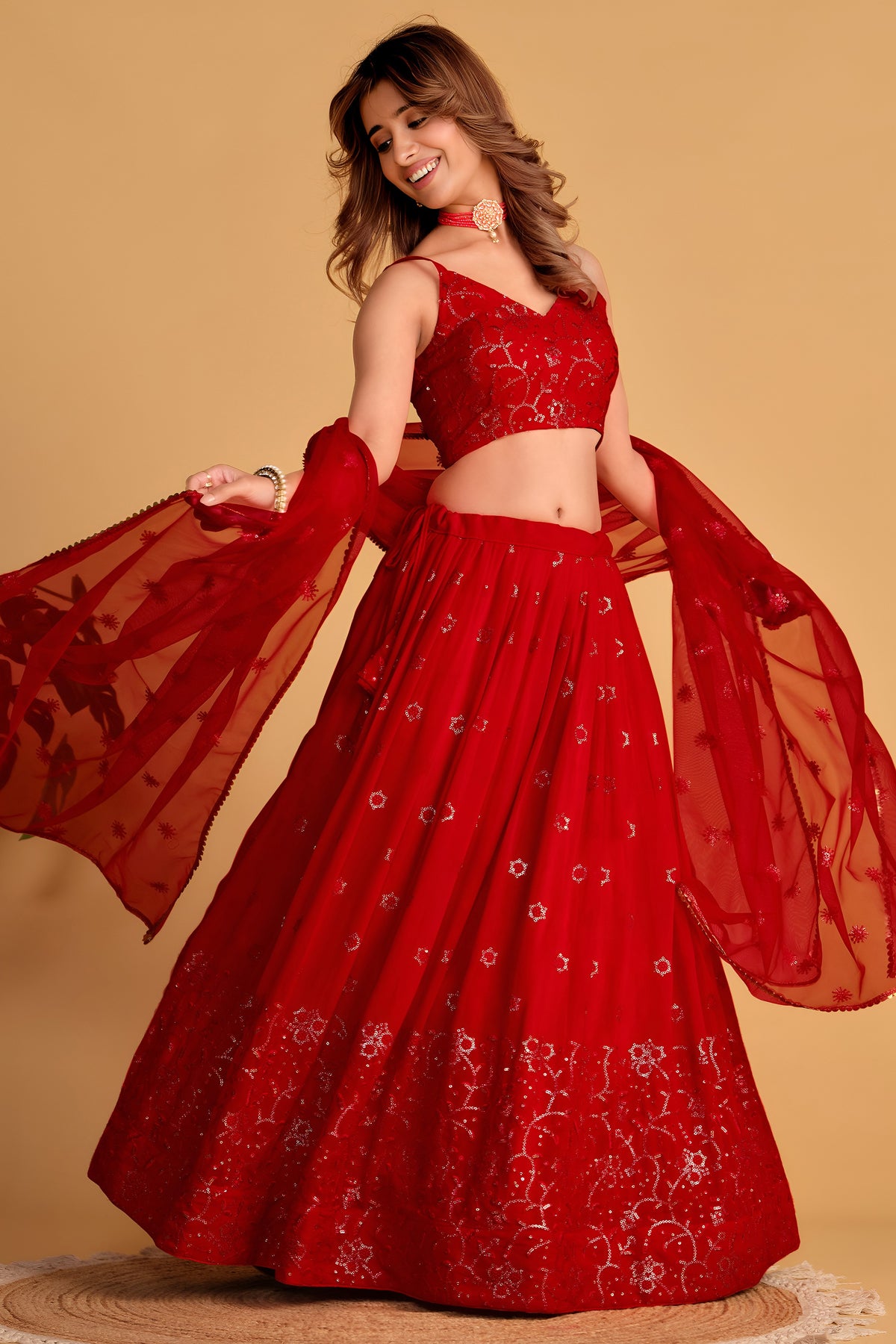 Alternate full-length view of a reddish pink engagement dresses for women lehenga with zari and sequin embroidery on the choli and lehenga.
