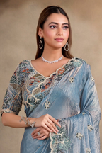 Powder Blue saree for engagement with pearl, thread and sequin handwork, front view showing the embellished blouse and detailed border