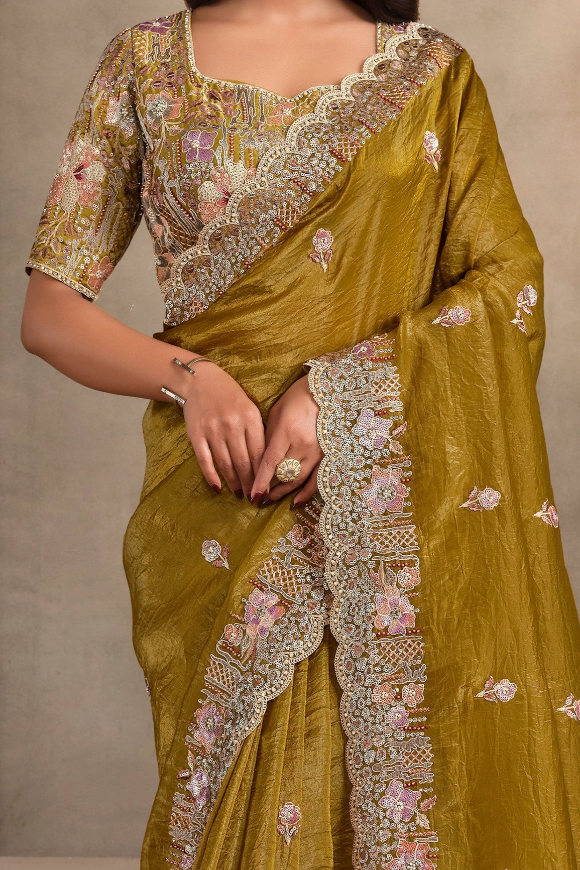 Mustard Olive sequin saree with pearl, thread and sequin handwork, waist-down view of the pleats and flowing saree drape