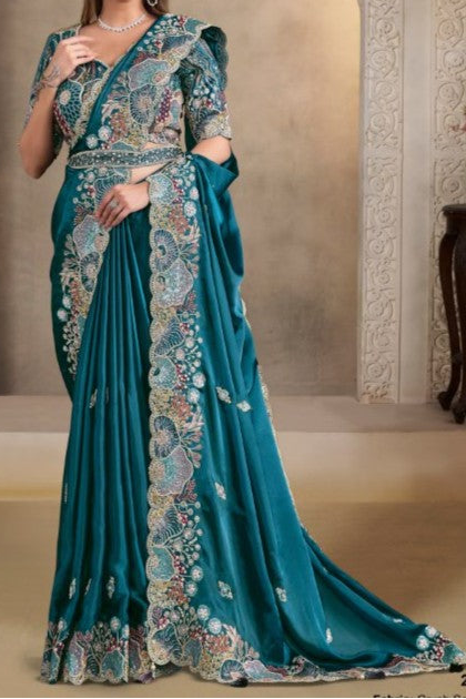Teal satin saree with sequin, pearl and handwork, upper-body closeup of the embroidery and handwork detailing