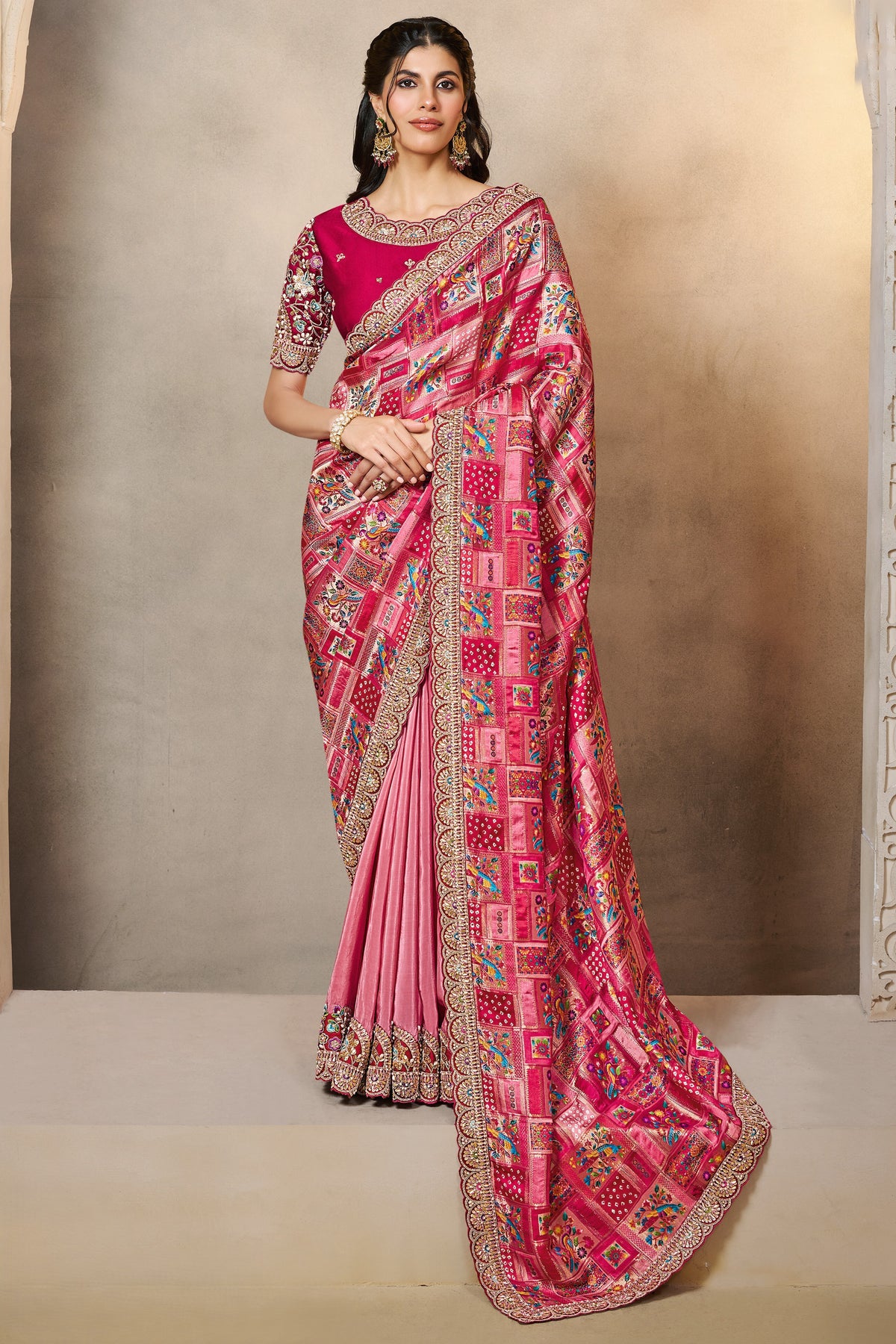 Reddish Pink indian wedding guest saree with thread embroidery and stone handwork, full front view of the model wearing the draped saree