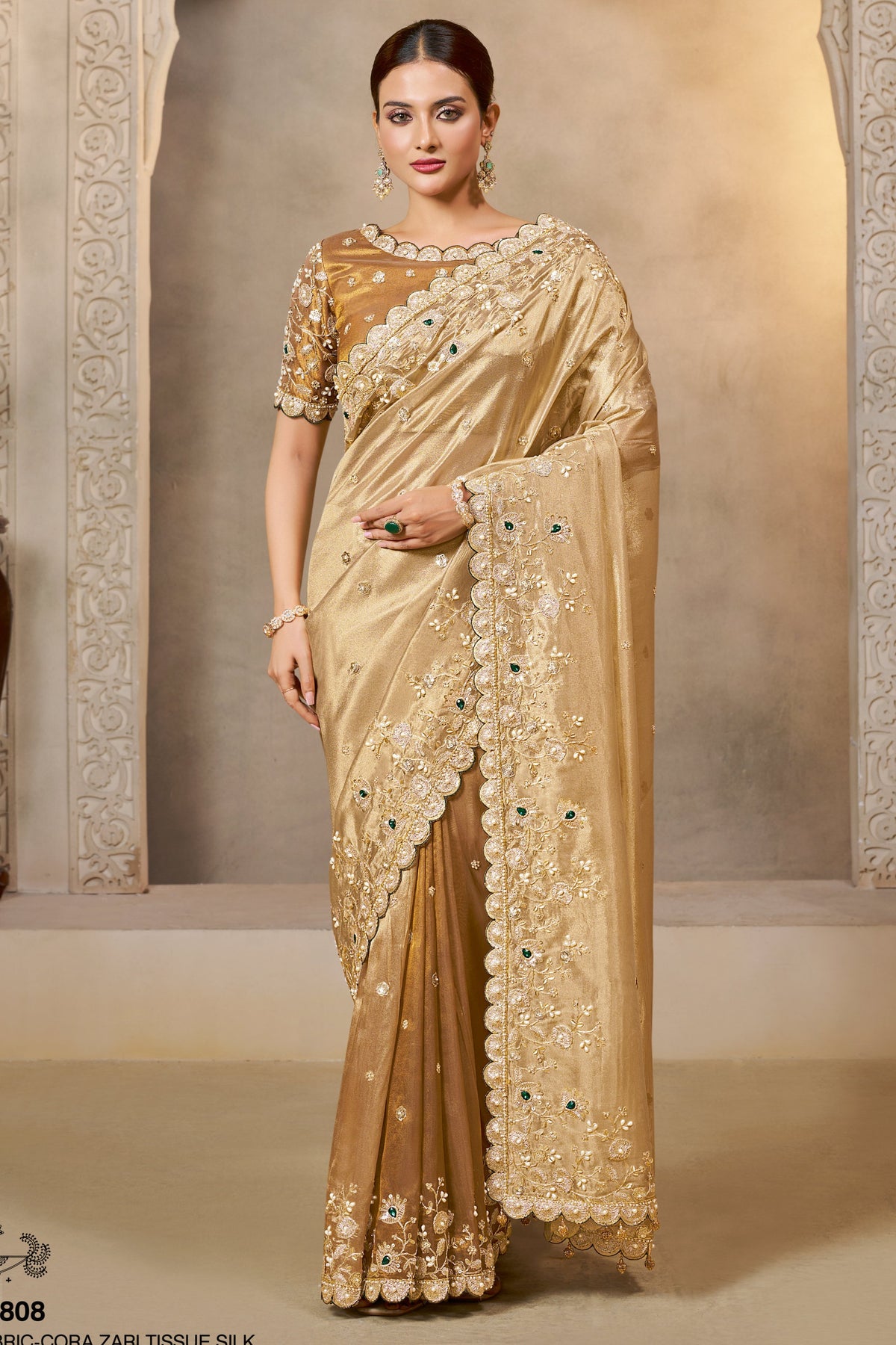 Champagne Golden saree for wedding with zardozi and stone handwork, full front view of the model wearing the draped saree