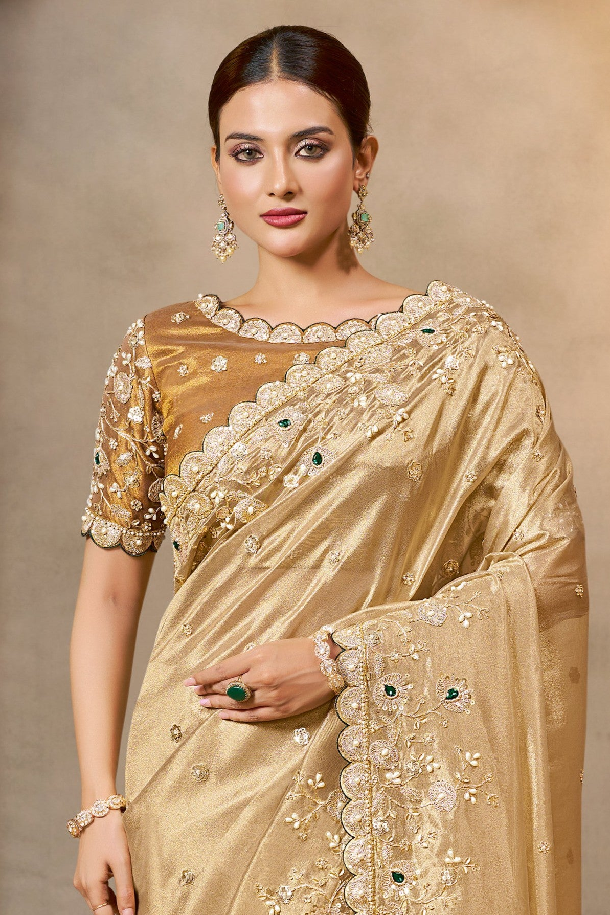 Champagne Golden satin saree with zardozi and stone handwork, upper-body closeup of the embroidery and handwork detailing