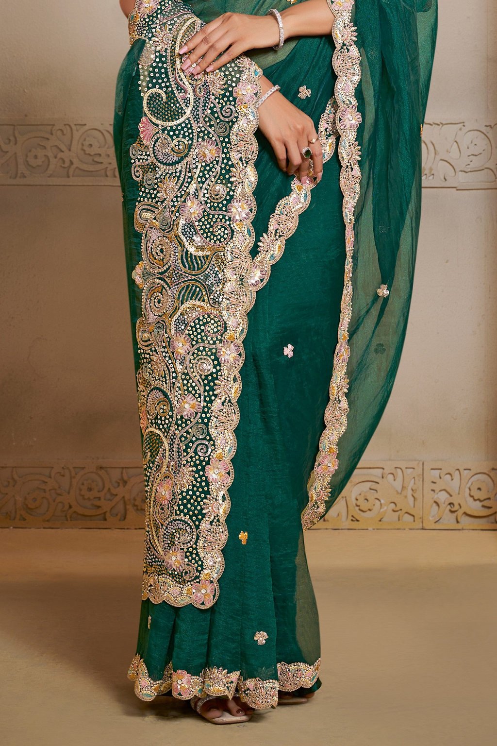 Emerald Green organza saree with thread embroidery and stone handwork, upper-body closeup of the embroidery and handwork detailing
