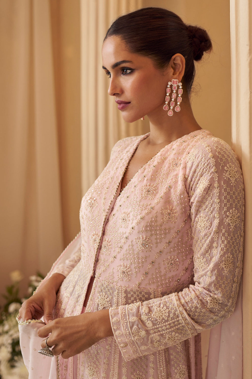 light pink anarkali of women standing and looking other side