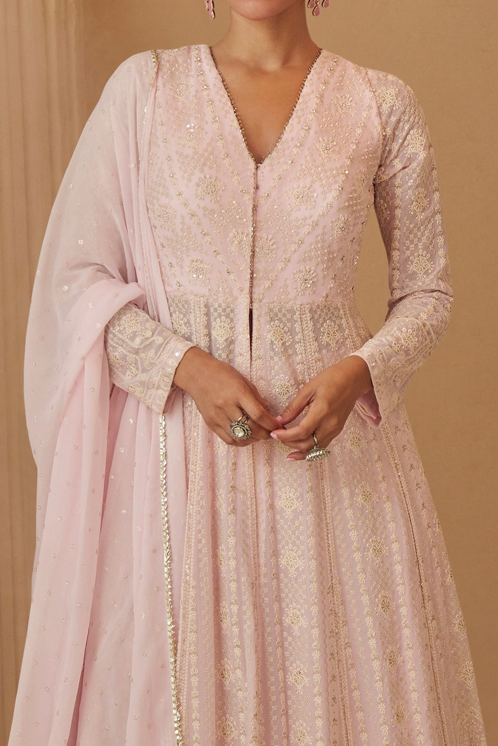 Close up view of women in light pink anarkali set 