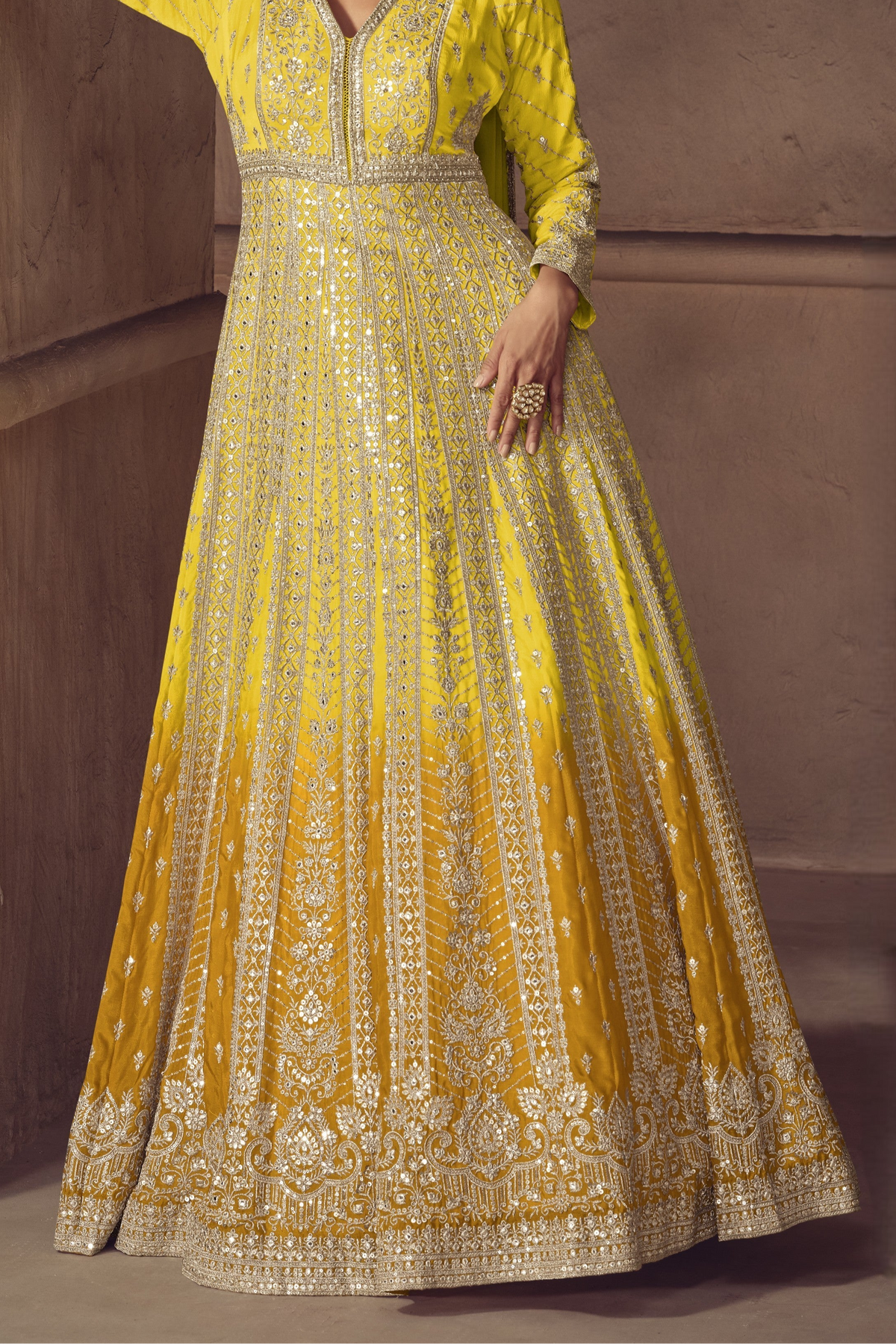 Lower front view of Yellow anarkali salwar suit side view with flowing flared skirt