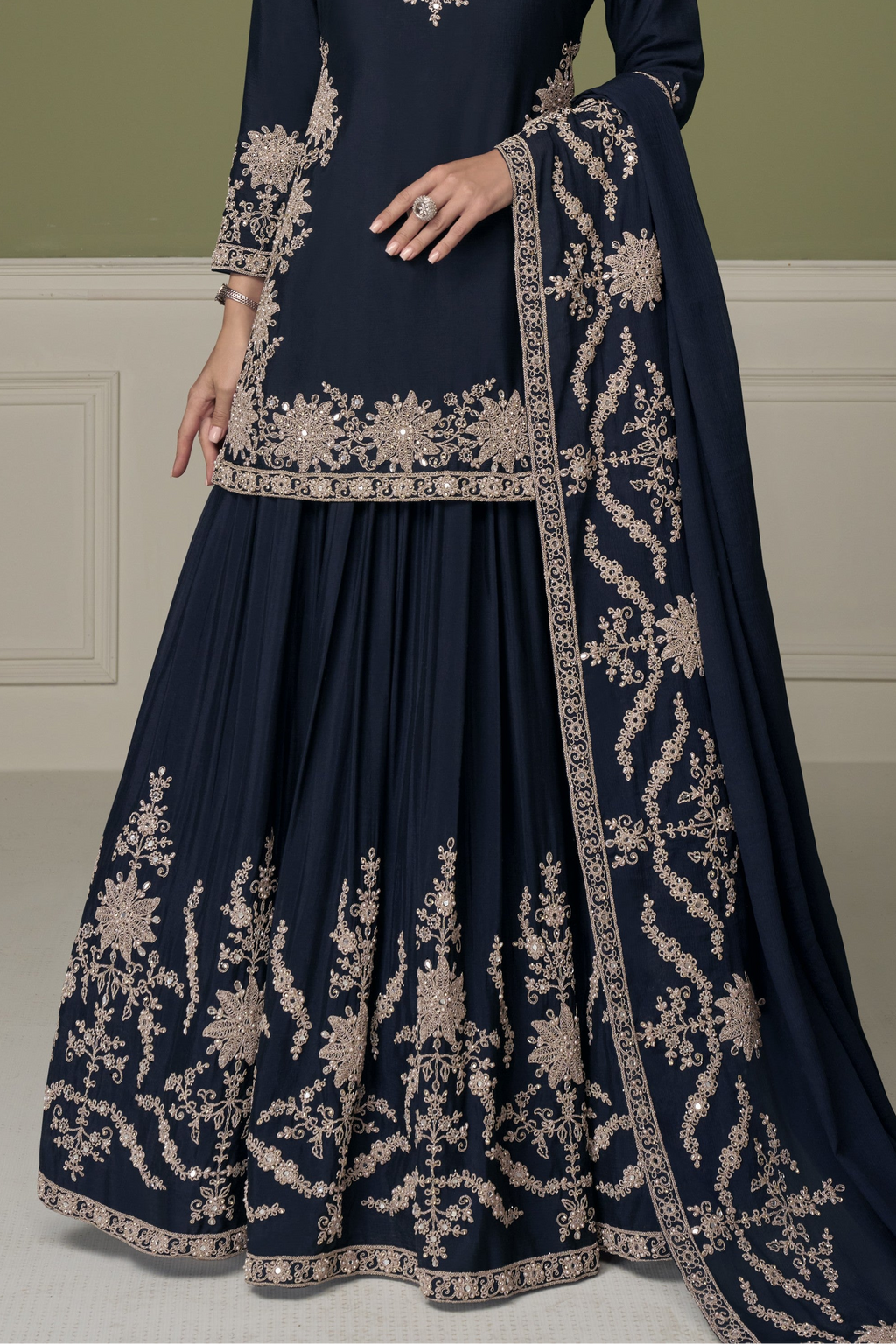 Navy blue indian kurta for women, waist-down view showing embroidered skirt with mirror and moti work.