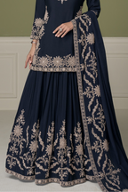 Navy blue indian kurta for women, waist-down view showing embroidered skirt with mirror and moti work.