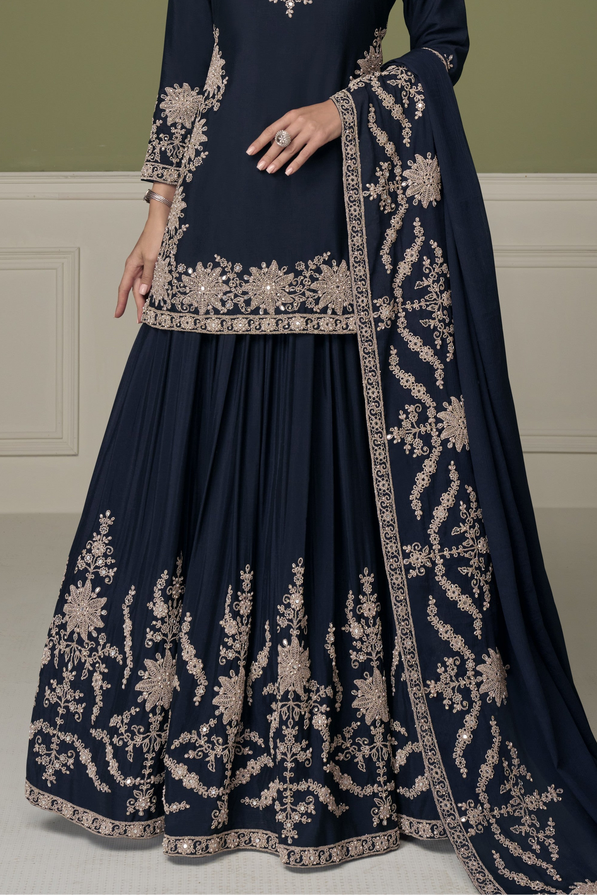 Navy blue indian kurta for women, waist-down view showing embroidered skirt with mirror and moti work.
