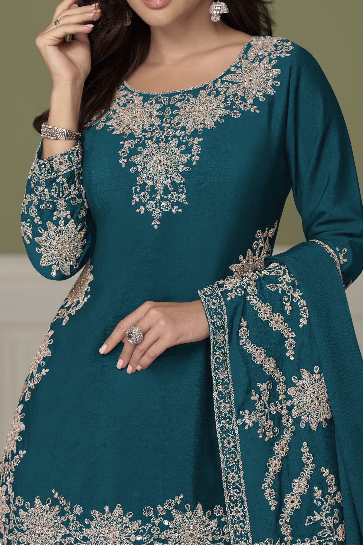 A woman modeling a kurta with intricate embroidery, paired with a matching dupatta closeup view