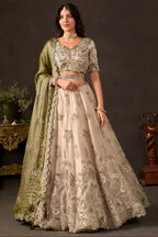Light beige sangeet lehenga choli, full front view on model, with zari and sequin embroidery on fendy silk.