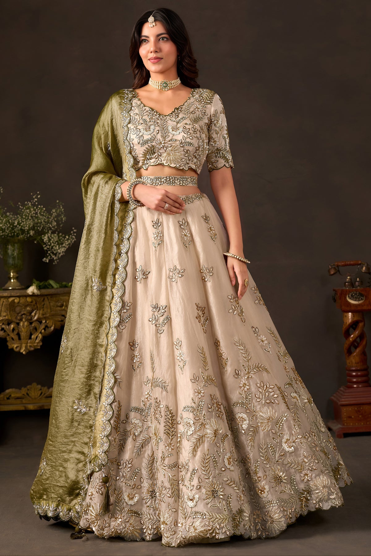 Light beige sangeet lehenga choli, full front view on model, with zari and sequin embroidery on fendy silk.