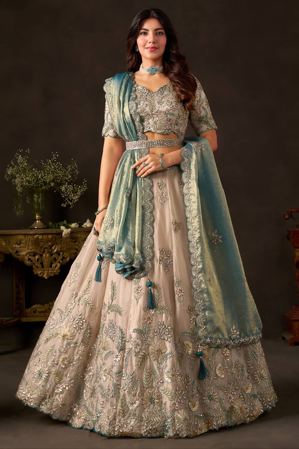 Light beige lehenga choli for sangeet, full front view on model, with zari and sequin embroidery on fendy silk.