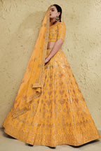 Alternate full-length view of a mustard yellow haldi outfits lehenga in art silk with zari and sequin embroidery work on the blouse and lehenga.