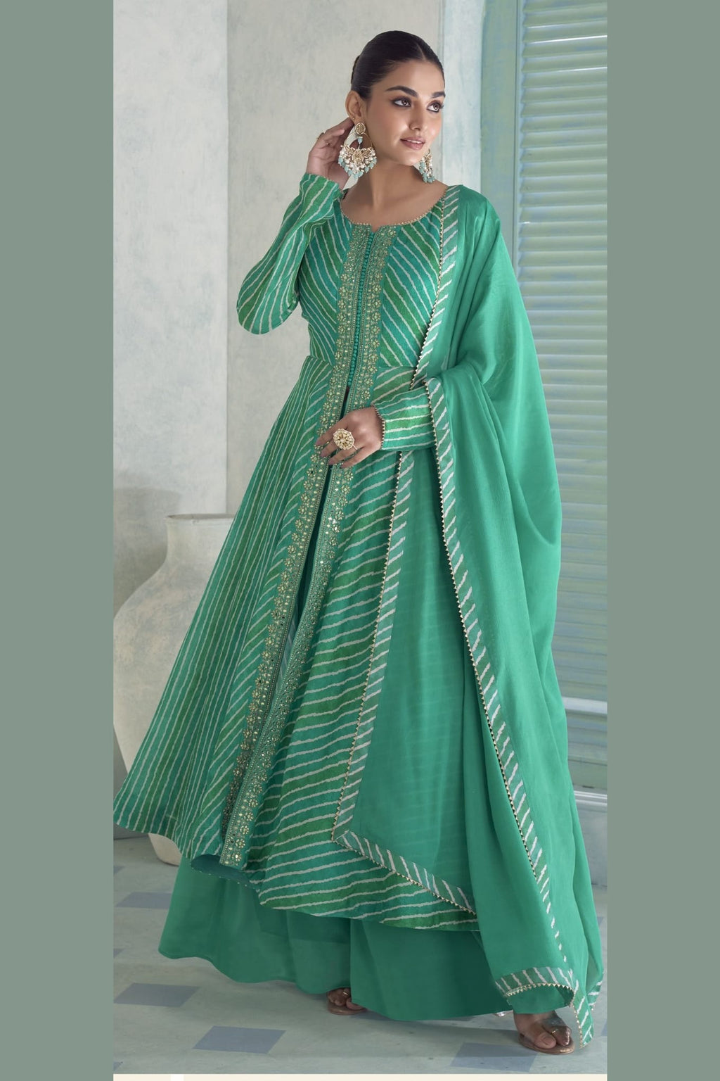 Model in the emerald green plazo suit with the chinon silk dupatta draped along one side.