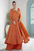 Model in the orange plazo suit showing the flared kameez and matching chinon silk dupatta.