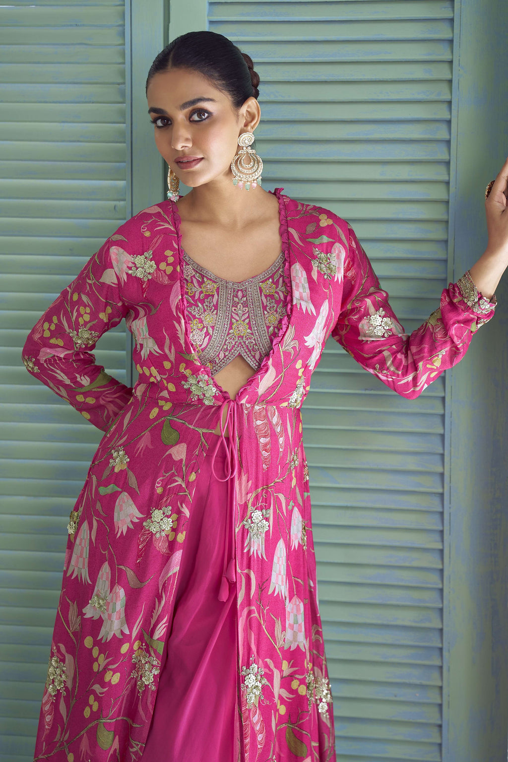 Close-up of the hot pink palazzo suit's embroidered blouse and floral print jacket.