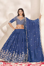 Full-length front view of a dusty blue lehenga for wedding in chinon silk with sequin and thread embroidery and a flowing embroidered dupatta.