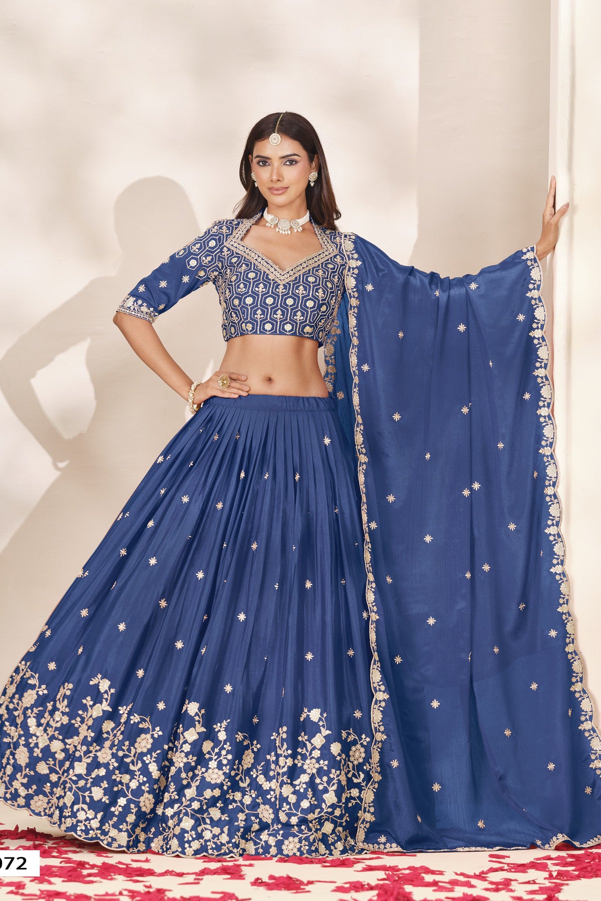 Full-length front view of a dusty blue lehenga for wedding in chinon silk with sequin and thread embroidery and a flowing embroidered dupatta.