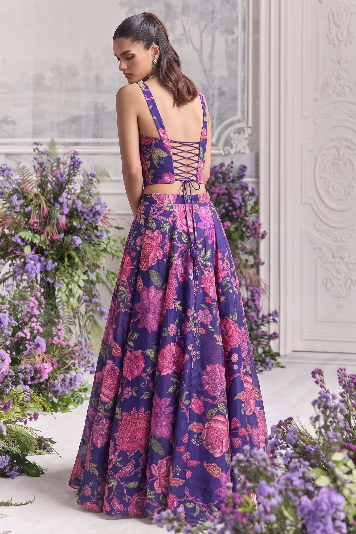 Back view of the blue lehenga choli, highlighting the deep neckline and criss-cross lace-up back tie.