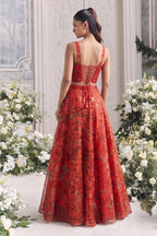 Back view of the red lehenga choli, showing the deep neckline with a delicate criss-cross tie-up.