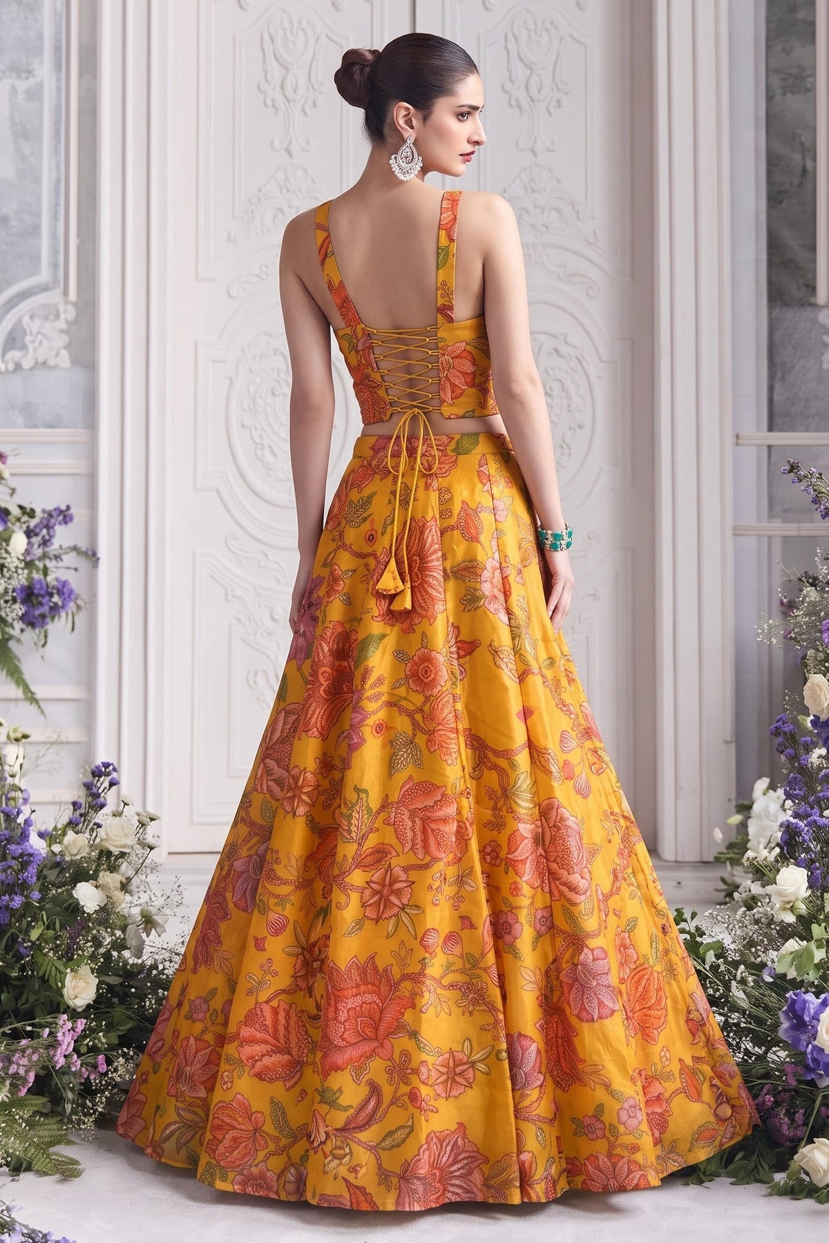 Back view of the mustard yellow lehenga choli, showing the deep neckline and lace-up back tie.