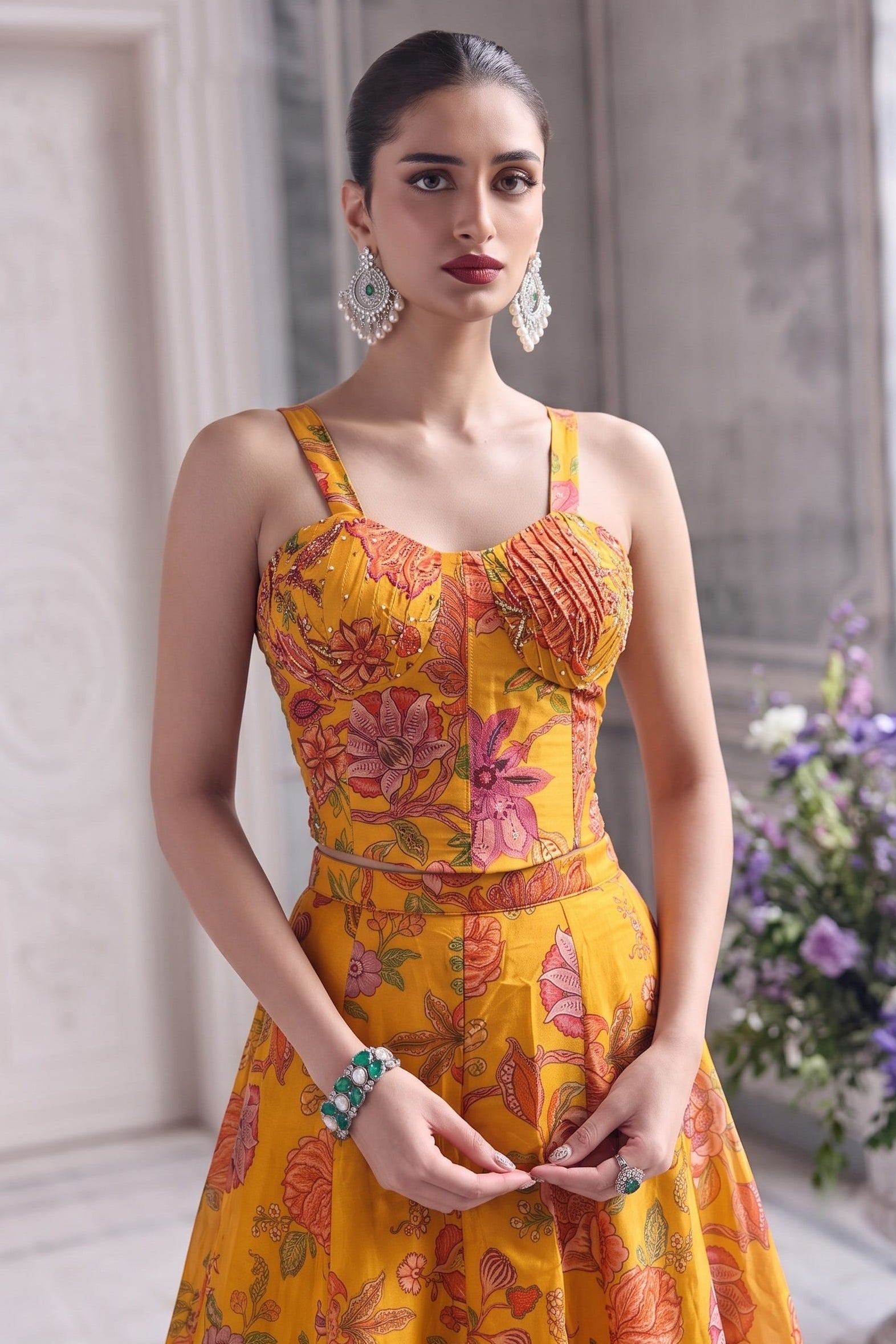 Close-up of the mustard yellow blouse's pleated bust with vivid floral print.