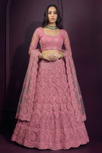Coral pink engagement lehenga in net with hand-worked embroidery, long-sleeve blouse and dupatta draped over both shoulders.