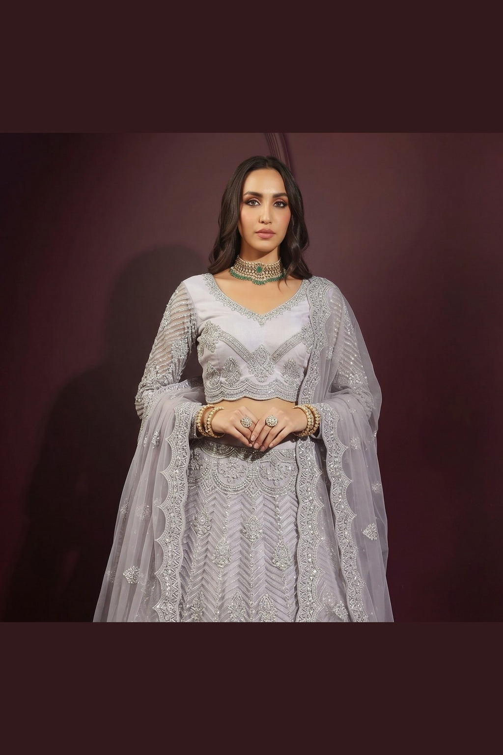 Full front view of the lavender grey indian lehenga choli with long-sleeve embroidered blouse and sheer dupatta draped on both arms.