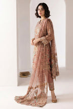 Side view of the light brown indian kurta for women showing the embroidered kameez, straight pant and the full length of the sheer net dupatta.