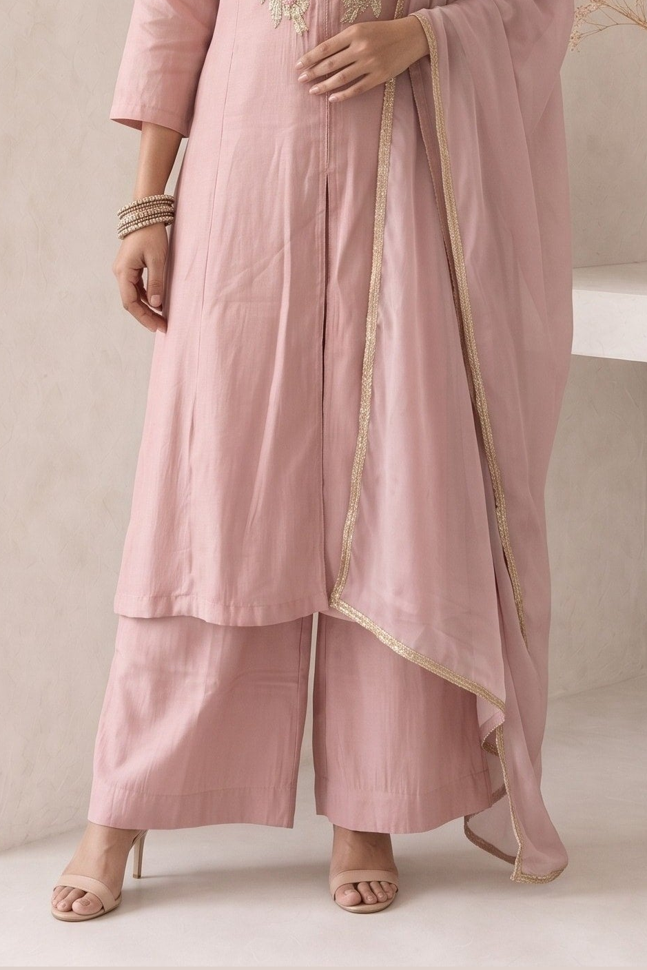 Waist-down view of a pale peach diwali outfits for women kurta set, ankle-length pants paired with an embroidered A-line kurta in roman silk.