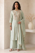Full-length side view of pastel mint green engagement dresses for women, an A-line kurta with ankle-length pants in roman silk fabric.
