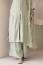 Waist-down view of pastel mint green diwali outfits for women, ankle-length pants paired with an embroidered A-line kurta in roman silk.