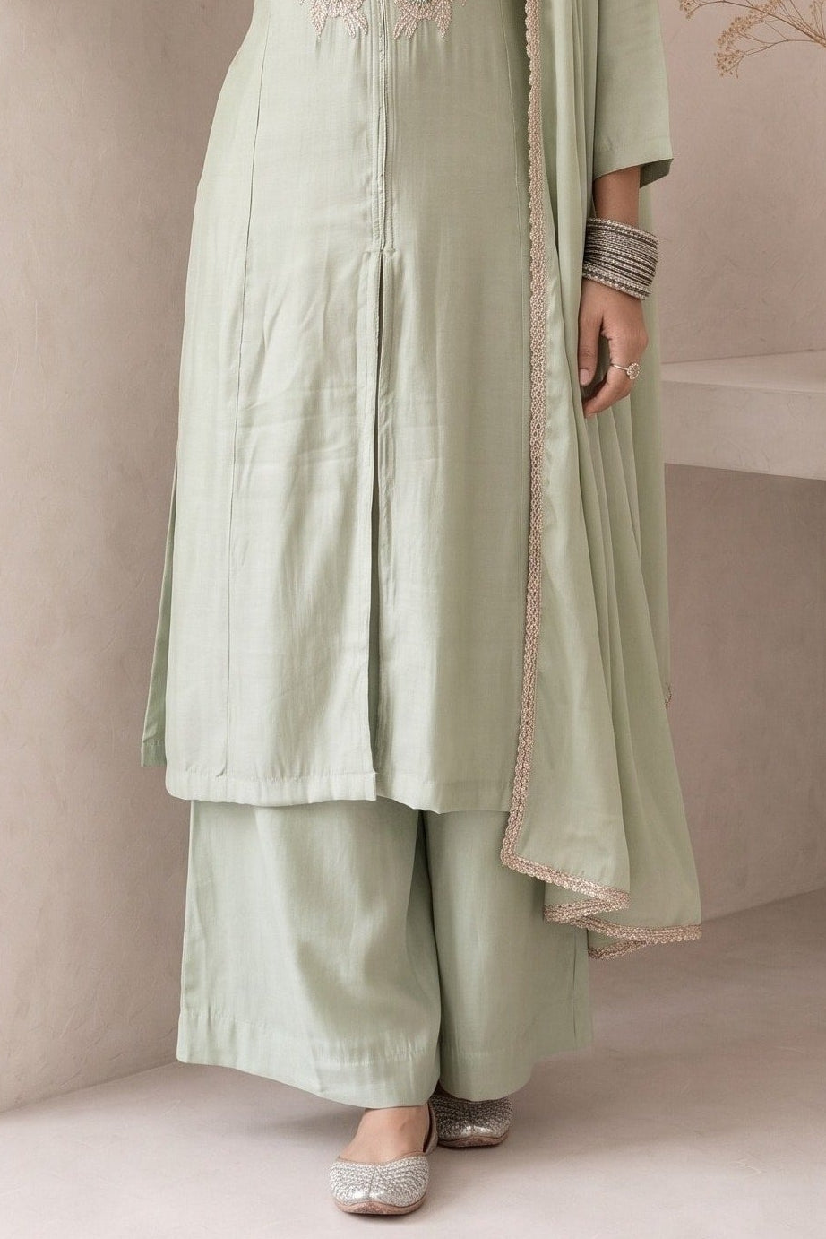 Waist-down view of pastel mint green diwali outfits for women, ankle-length pants paired with an embroidered A-line kurta in roman silk.