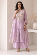 Full-length side view of a pinkish lavender festive wear for women kurta set, an A-line kurta with ankle-length pants in roman silk.