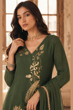 Close-up of olive green diwali outfits for women kurta with gold zari and sequin work on the V neckline and three-quarter sleeves.